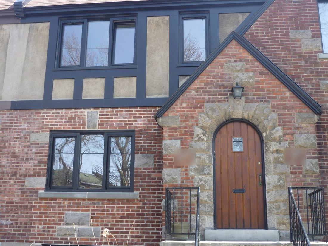 Brick and stucco house with new black-framed windows